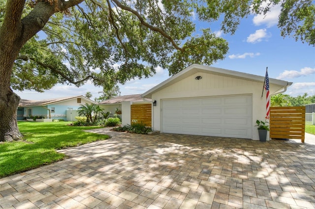 1286 Stony Brook Ln, Dunedin, FL 34698 - view of front of house with a garage, decorative driveway, and stucco siding
