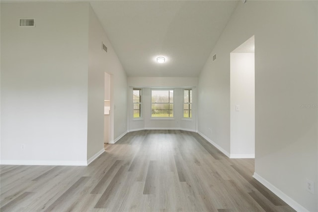 1209 Sugar Creek Ln, Rockledge, FL 32955 - empty room with lofted ceiling, light wood finished floors, and baseboards