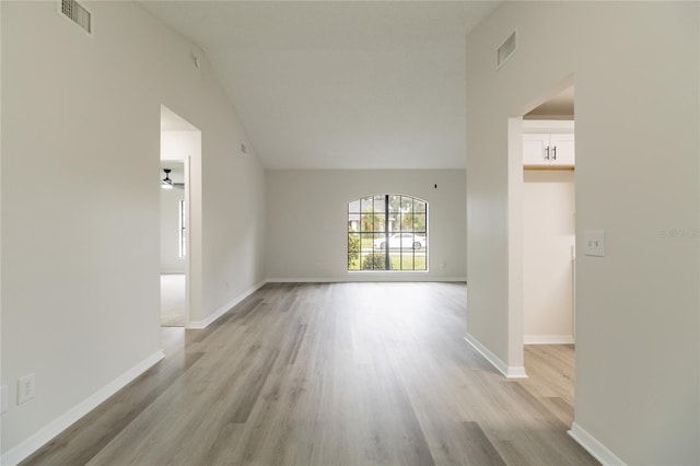 1209 Sugar Creek Ln, Rockledge, FL 32955 - unfurnished room with light wood-style floors, vaulted ceiling, and baseboards