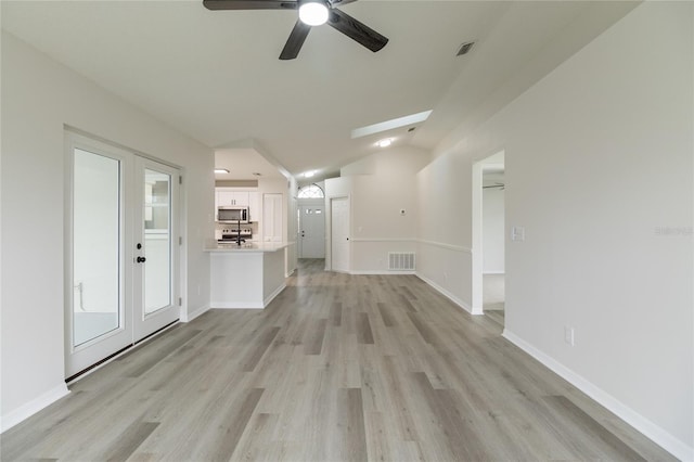 1209 Sugar Creek Ln, Rockledge, FL 32955 - unfurnished living room featuring ceiling fan, light wood finished floors, vaulted ceiling, and baseboards