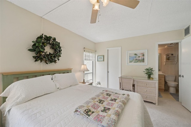 7304 W Country Club Dr N Unit 113, Sarasota, FL 34243 - bedroom with light carpet, a textured ceiling, ensuite bathroom, and ceiling fan