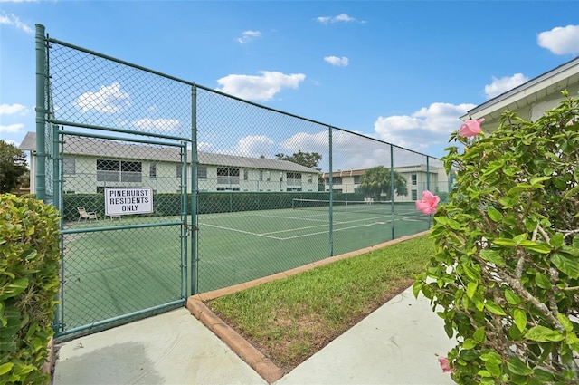 7304 W Country Club Dr N Unit 113, Sarasota, FL 34243 - view of tennis court featuring a gate