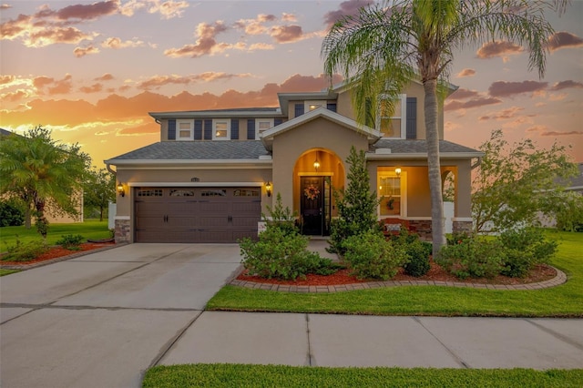 5624 Fisher Glen Loop, Wesley Chapel, FL 33545 - view of front facade featuring stone siding, stucco siding, concrete driveway, and an attached garage