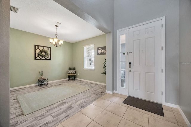 5624 Fisher Glen Loop, Wesley Chapel, FL 33545 - entrance foyer with a chandelier, light wood-type flooring, and baseboards