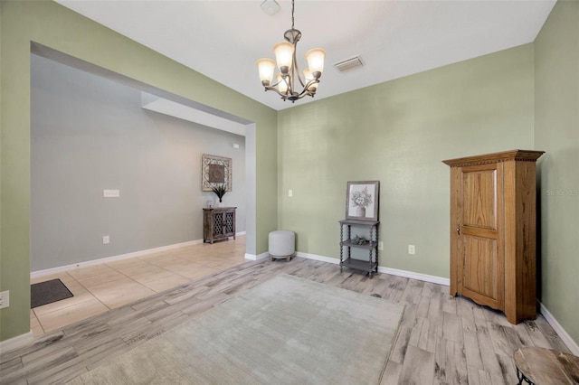 5624 Fisher Glen Loop, Wesley Chapel, FL 33545 - spare room with light wood-style flooring, a chandelier, and baseboards