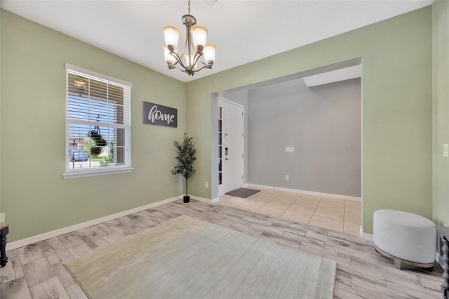 5624 Fisher Glen Loop, Wesley Chapel, FL 33545 - foyer with wood finished floors, a chandelier, and baseboards
