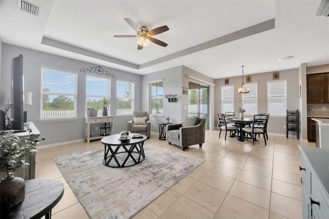 5624 Fisher Glen Loop, Wesley Chapel, FL 33545 - living area with a raised ceiling, a ceiling fan, light tile patterned floors, baseboards, and a chandelier