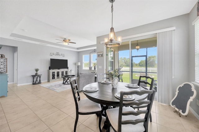 5624 Fisher Glen Loop, Wesley Chapel, FL 33545 - dining area featuring light tile patterned flooring, a tray ceiling, a ceiling fan, and baseboards