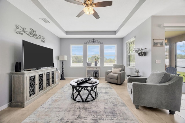 5624 Fisher Glen Loop, Wesley Chapel, FL 33545 - living room with a raised ceiling, tile patterned flooring, plenty of natural light, and a ceiling fan
