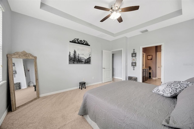 5624 Fisher Glen Loop, Wesley Chapel, FL 33545 - bedroom featuring a raised ceiling, light colored carpet, baseboards, and ceiling fan