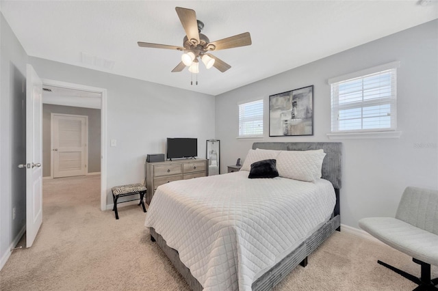 5624 Fisher Glen Loop, Wesley Chapel, FL 33545 - bedroom featuring light colored carpet, baseboards, and a ceiling fan