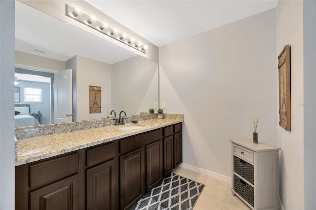 5624 Fisher Glen Loop, Wesley Chapel, FL 33545 - ensuite bathroom featuring vanity, baseboards, and tile patterned floors