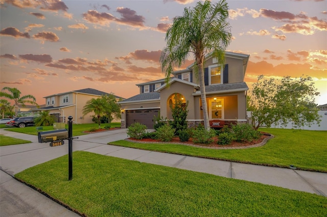 5624 Fisher Glen Loop, Wesley Chapel, FL 33545 - traditional home featuring stucco siding, driveway, a front yard, a garage, and stone siding