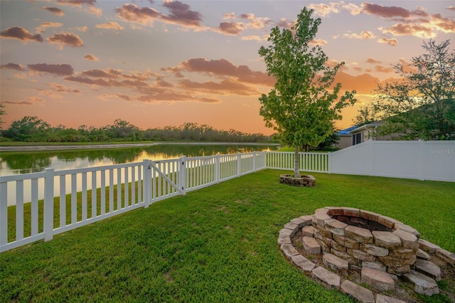 5624 Fisher Glen Loop, Wesley Chapel, FL 33545 - yard at dusk with a fire pit and a water view