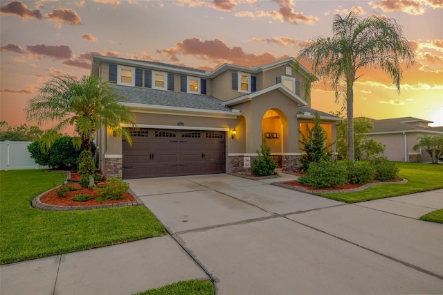 5624 Fisher Glen Loop, Wesley Chapel, FL 33545 - view of front of property featuring stone siding, driveway, stucco siding, and a garage
