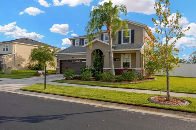 5624 Fisher Glen Loop, Wesley Chapel, FL 33545 - view of front facade featuring stucco siding, stone siding, concrete driveway, and an attached garage