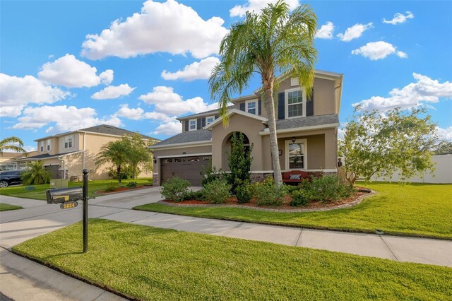 5624 Fisher Glen Loop, Wesley Chapel, FL 33545 - traditional home with stucco siding, concrete driveway, a front yard, stone siding, and a garage