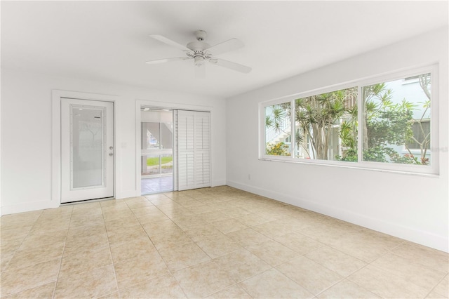 241 Skiff Pt Unit 1, Clearwater Beach, FL 33767 - tiled spare room with baseboards and a ceiling fan
