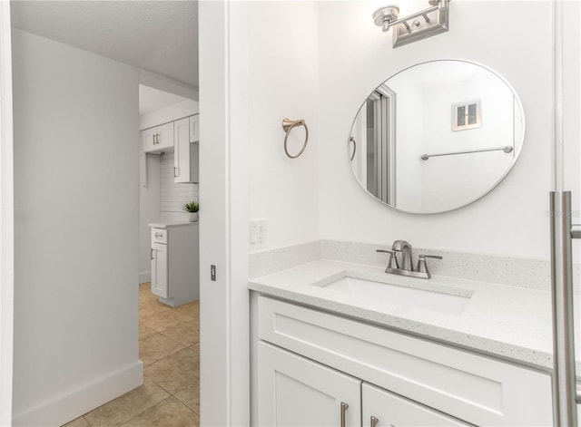 241 Skiff Pt Unit 1, Clearwater Beach, FL 33767 - bathroom featuring tile patterned flooring, vanity, and baseboards