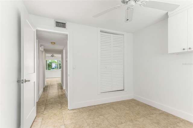 241 Skiff Pt Unit 1, Clearwater Beach, FL 33767 - unfurnished bedroom with a closet, baseboards, ceiling fan, and light tile patterned floors
