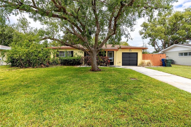614 12th St NW, Largo, FL 33770 - ranch-style house with concrete driveway, a garage, and stucco siding