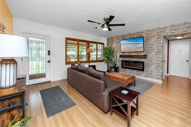 614 12th St NW, Largo, FL 33770 - living room with wood finished floors, a ceiling fan, and a fireplace