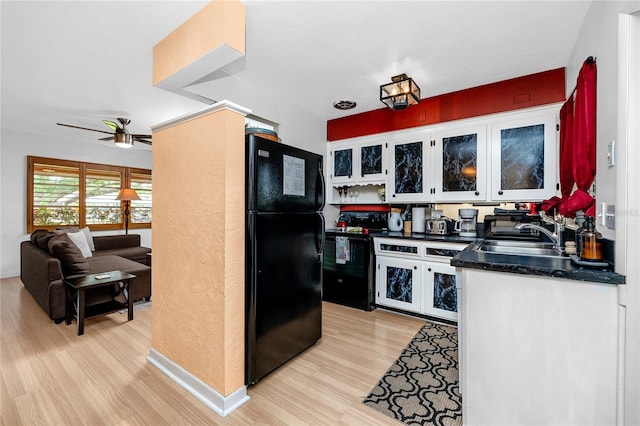 614 12th St NW, Largo, FL 33770 - kitchen featuring black appliances, dark countertops, light wood finished floors, a ceiling fan, and glass insert cabinets