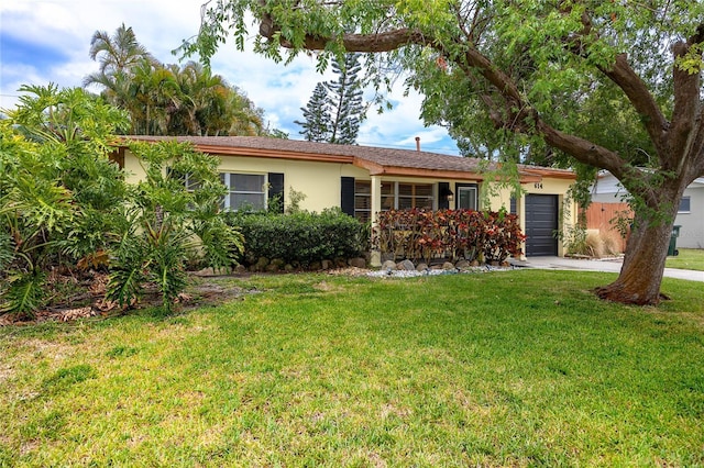 614 12th St NW, Largo, FL 33770 - ranch-style home with an attached garage, stucco siding, a front yard, and concrete driveway