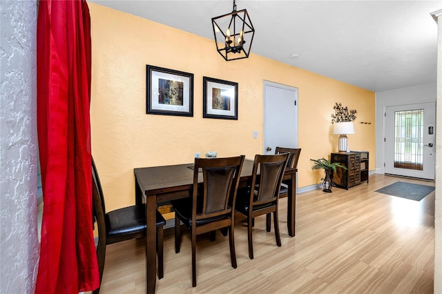 614 12th St NW, Largo, FL 33770 - dining area with a chandelier and wood finished floors