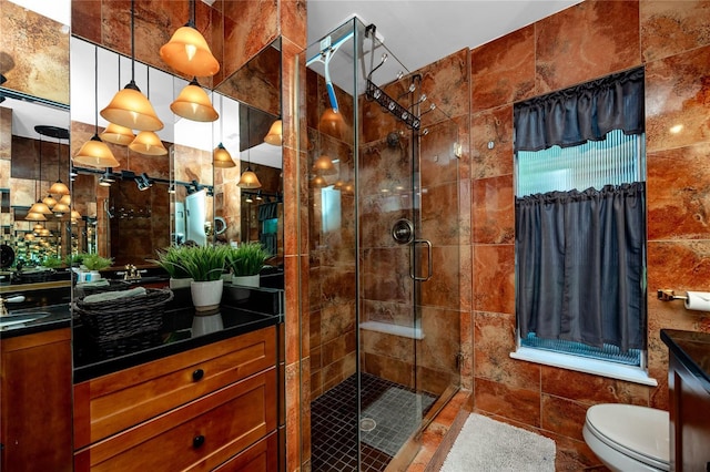 614 12th St NW, Largo, FL 33770 - bathroom with vanity, a shower stall, and tile walls