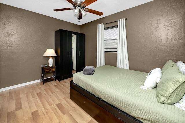 614 12th St NW, Largo, FL 33770 - bedroom with a textured wall, light wood-type flooring, and ceiling fan