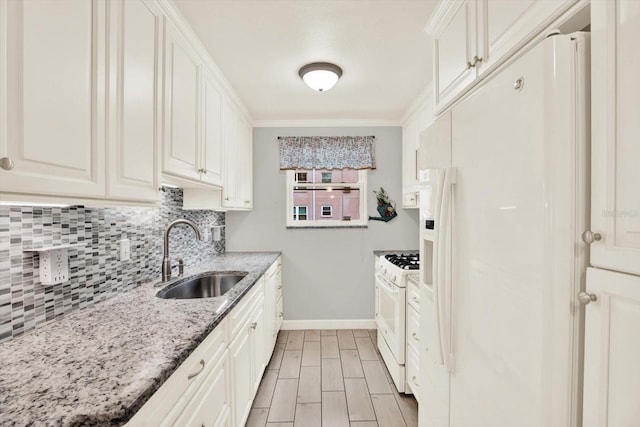 5501 80th St N Unit 206, Saint Petersburg, FL 33709 - kitchen with white appliances, tasteful backsplash, light stone countertops, white cabinets, and ornamental molding