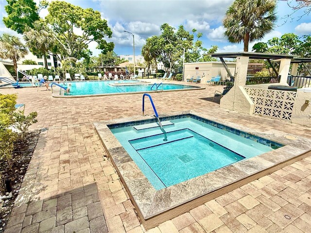 5501 80th St N Unit 206, Saint Petersburg, FL 33709 - community pool featuring a hot tub and a patio