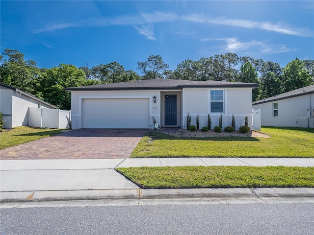 573 Vista Villages Blvd, Davenport, FL 33896 - view of front of property with decorative driveway, stucco siding, a garage, and a gate