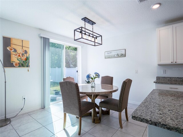 573 Vista Villages Blvd, Davenport, FL 33896 - dining space with a textured ceiling, baseboards, light tile patterned floors, and recessed lighting