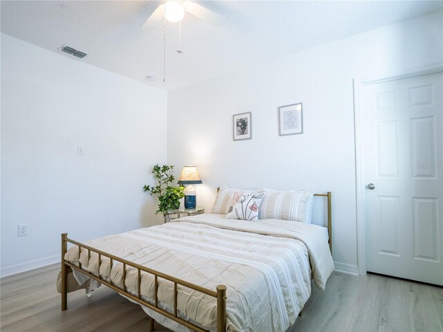 573 Vista Villages Blvd, Davenport, FL 33896 - bedroom with light wood finished floors, baseboards, and ceiling fan