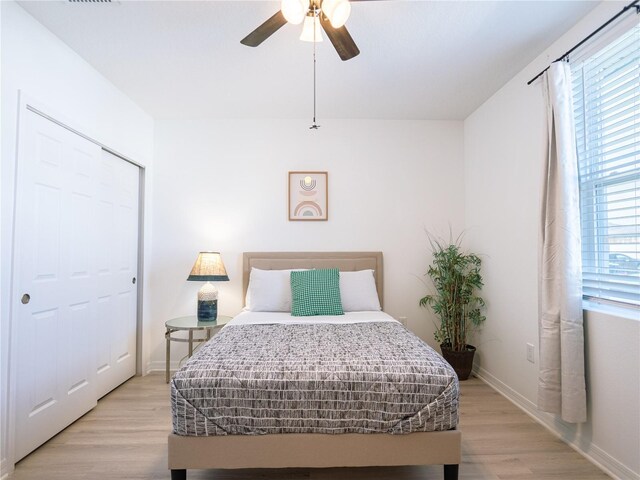 573 Vista Villages Blvd, Davenport, FL 33896 - bedroom with light wood finished floors, baseboards, a ceiling fan, and a closet