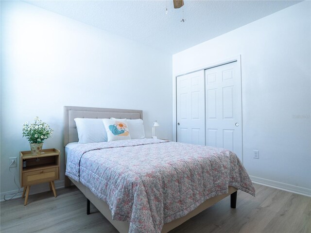 573 Vista Villages Blvd, Davenport, FL 33896 - bedroom featuring light wood-style floors, baseboards, a closet, and ceiling fan