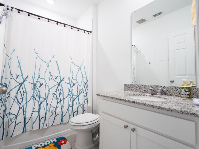 573 Vista Villages Blvd, Davenport, FL 33896 - bathroom featuring vanity, shower / bath combo with shower curtain, and toilet