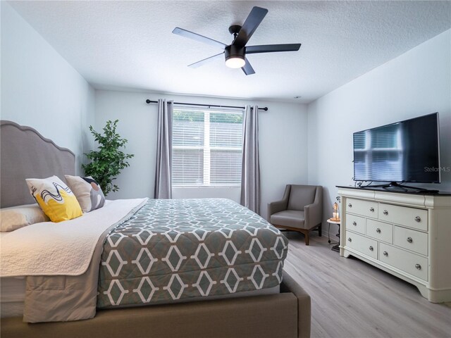 573 Vista Villages Blvd, Davenport, FL 33896 - bedroom with wood finished floors, a textured ceiling, and a ceiling fan