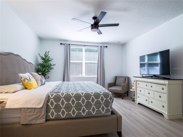 573 Vista Villages Blvd, Davenport, FL 33896 - bedroom featuring wood finished floors, a textured ceiling, and a ceiling fan