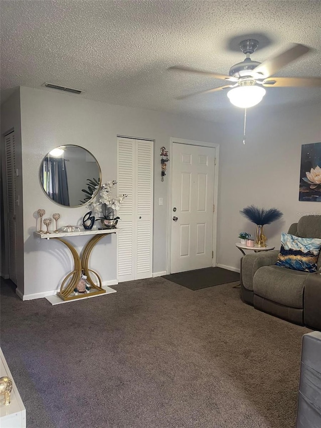 3802 Cortez Cir Unit D, Tampa, FL 33614 - carpeted living area with a ceiling fan, baseboards, and a textured ceiling