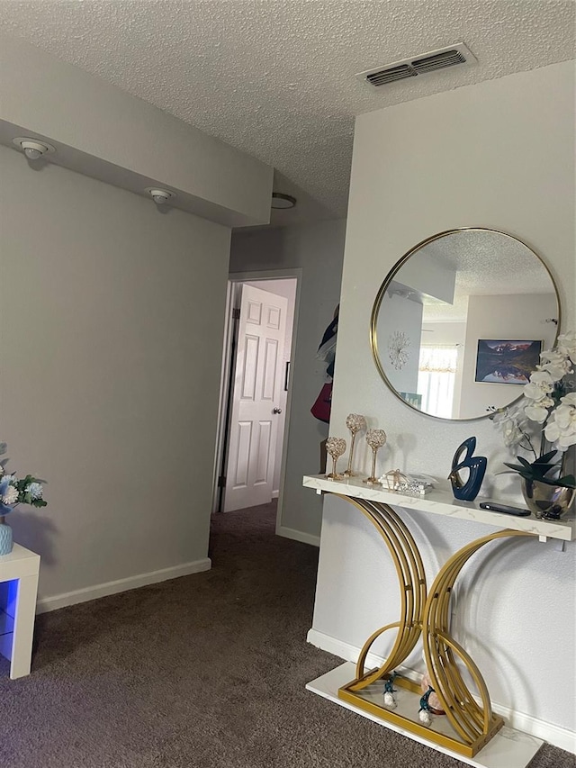 3802 Cortez Cir Unit D, Tampa, FL 33614 - corridor with a textured ceiling, dark carpet, and baseboards