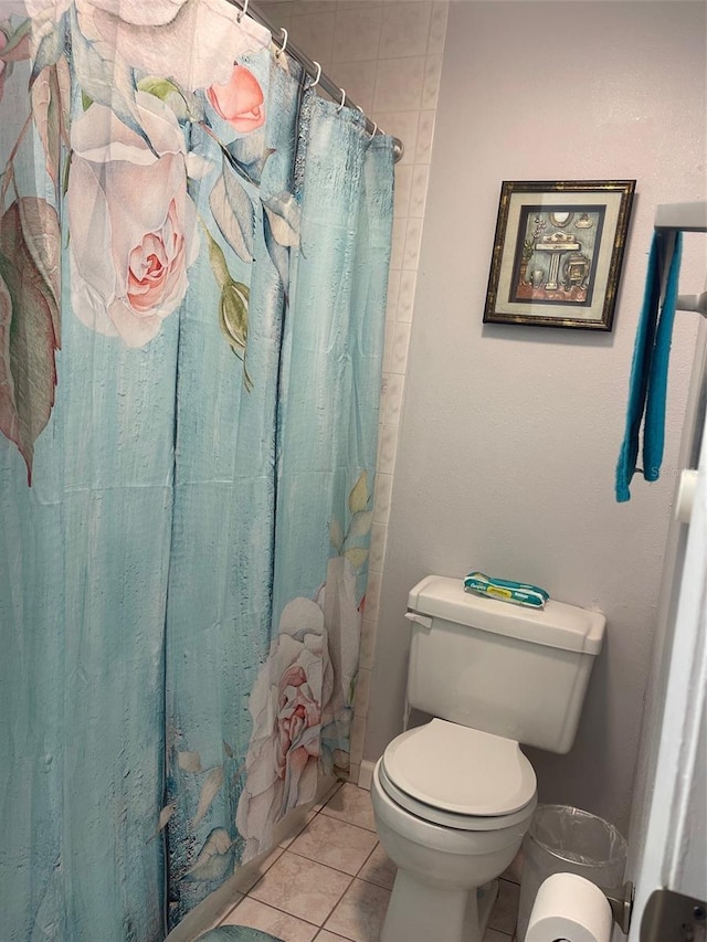 3802 Cortez Cir Unit D, Tampa, FL 33614 - bathroom featuring tile patterned floors, toilet, and curtained shower