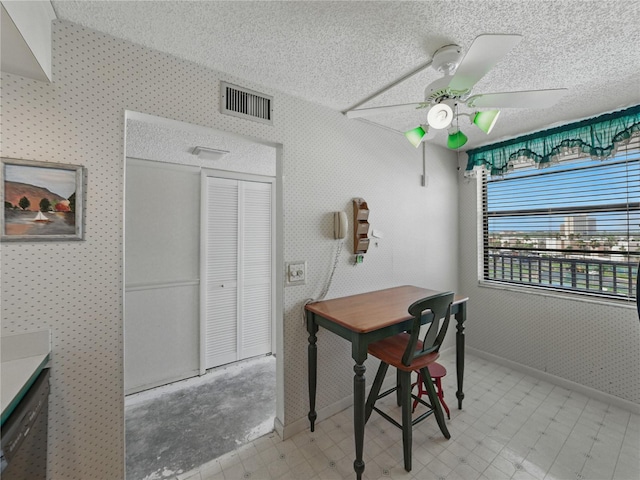 7600 Sun Island Dr S Unit 603, South Pasadena, FL 33707 - home office featuring a ceiling fan, a textured ceiling, wallpapered walls, and light floors