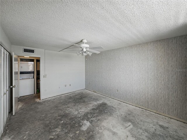 7600 Sun Island Dr S Unit 603, South Pasadena, FL 33707 - unfurnished bedroom featuring unfinished concrete flooring, washer / dryer, a closet, a textured ceiling, and a ceiling fan