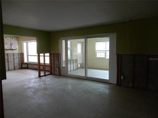 1897 Dolphin Blvd S, Saint Petersburg, FL 33707 - unfurnished room featuring unfinished concrete flooring and plenty of natural light
