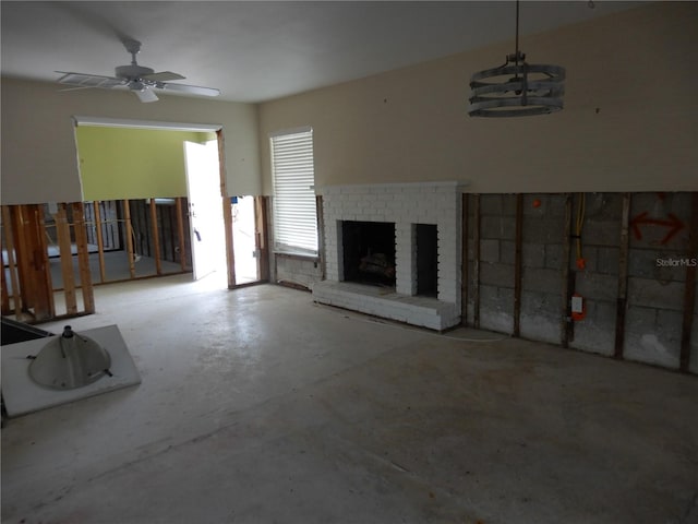 1897 Dolphin Blvd S, Saint Petersburg, FL 33707 - unfurnished living room featuring concrete floors, a brick fireplace, and a ceiling fan