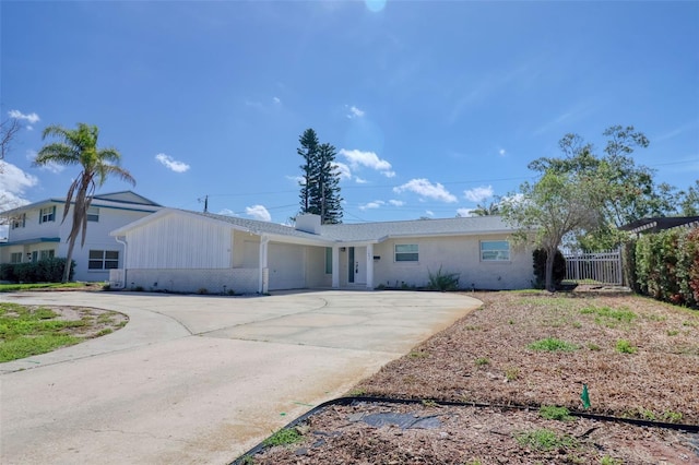 1897 Dolphin Blvd S, Saint Petersburg, FL 33707 - ranch-style home featuring an attached garage, driveway, brick siding, and board and batten siding