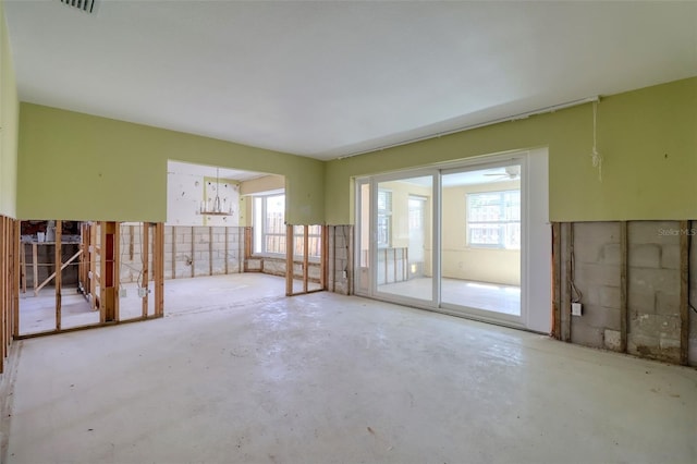 1897 Dolphin Blvd S, Saint Petersburg, FL 33707 - unfurnished living room featuring unfinished concrete floors